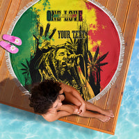 Round fringed beach blanket with reggae grunge print and "YOUR TEXT" shown from above.