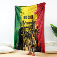 Personalized blanket draped indoors, featuring reggae grunge face on green and red