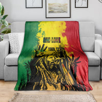 Personalized blanket on sofa with bold reggae grunge portrait in yellow, green, and red