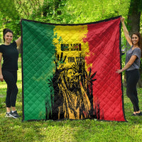 Quilt blanket showing green and red split with yellow center and graphic portrait design