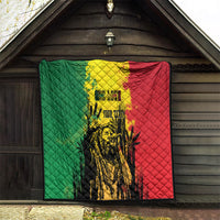 Quilt blanket hung in doorway with green left panel, red right panel, and yellow center art