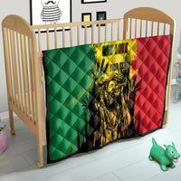 Baby quilt blanket in green, yellow, and red with diamond stitching and portrait artwork