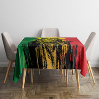 Tablecloth on dining table with green, yellow, black, and red illustrated grunge design