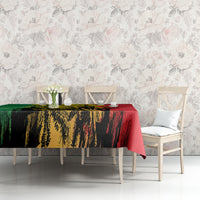 Tablecloth corner view with green and red grunge artwork over light dining set