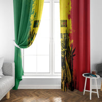 Window curtain pair draped on rod, green and red with yellow splatter and black botanical prints.