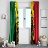 Window curtain pair hanging on door window, green and red panels with yellow splash center design.