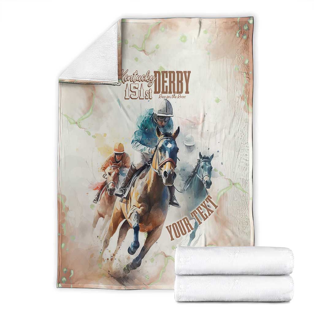 Beige horse racing blanket folded with Kentucky Derby 151st riders graphic, with two rolls