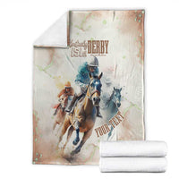 Beige horse racing blanket folded with Kentucky Derby 151st riders graphic, with two rolls