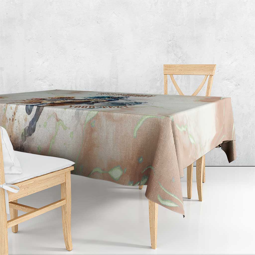 Beige horse-racing tablecloth draped over a table edge with colorful design