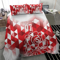 Red and white bedding set with geometric blocks, rose design, and 07 on the duvet