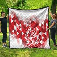White and red quilt blanket with red diamond pattern and rose “07” artwork
