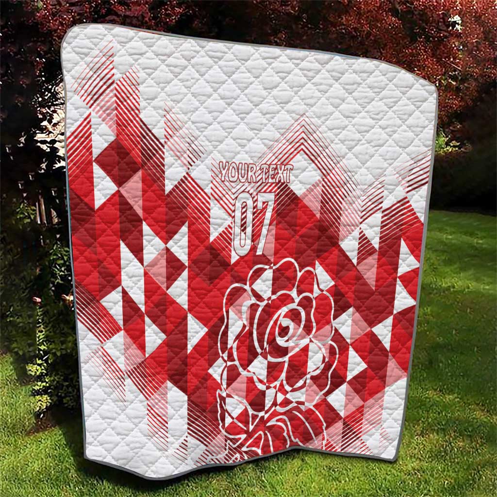 White and red quilted blanket with red geometric chevrons, rose graphic, and “07”