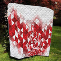 White and red quilted blanket with red geometric chevrons, rose graphic, and “07”