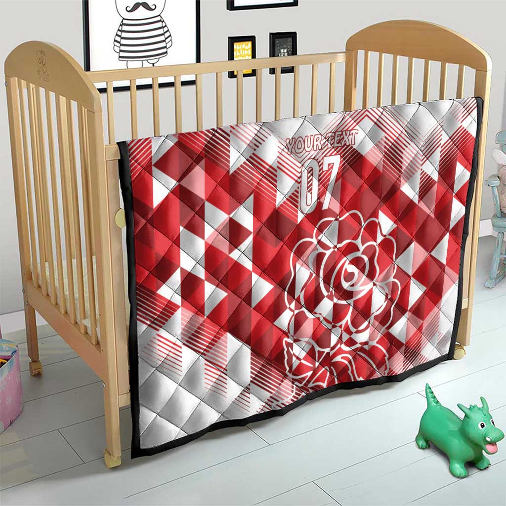 White and red quilt blanket for crib with diamond pattern, rose art, and “07”