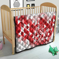 White and red quilt blanket for crib with diamond pattern, rose art, and “07”