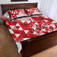 Red and white quilt bed set with rose graphic and '07' on quilt, styled on wooden bed