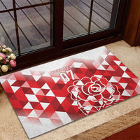Red and white rubber doormat with rose artwork and bold geometric triangles