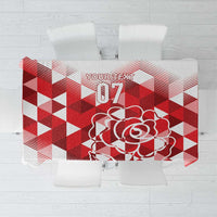 Red and white geometric tablecloth with rose graphic and '07' emblem