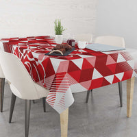 Red and white geometric tablecloth spread across a dining table