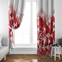 Red and white printed curtain panels framing a window with outlined rose detail