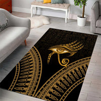 Black and gold Eye of Horus area rug with decorative border and wing motif