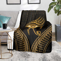 Black throw blanket featuring gold Eye of Horus and feathered wing artwork