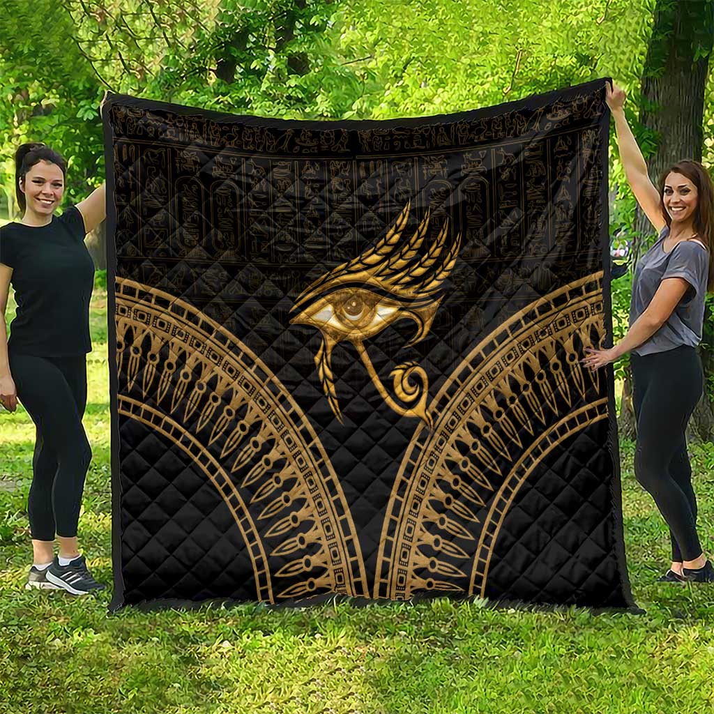 Black and gold Eye of Horus quilt with large central feather eye and arched borders