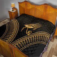 Black and gold Eye of Horus quilt over bed, quilted diamonds with feather center