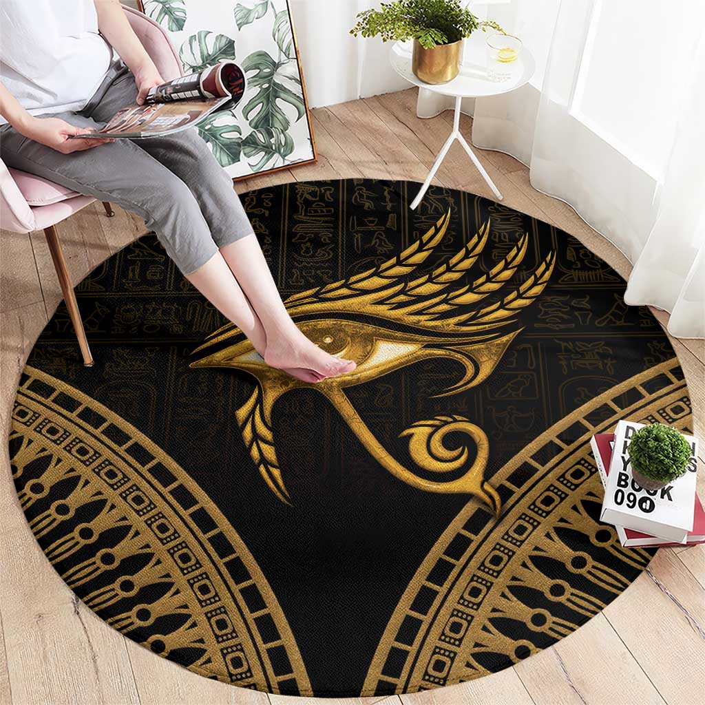Round dark carpet with gold Eye of Horus feather motif and ornate frame border