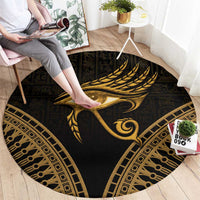 Round dark carpet with gold Eye of Horus feather motif and ornate frame border