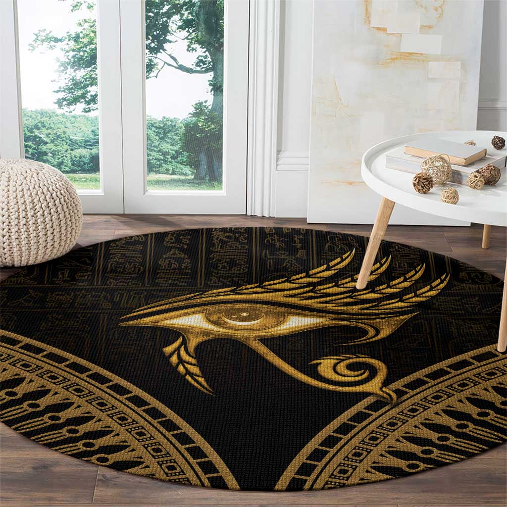 Round dark carpet featuring a gold Eye of Horus and feather, geometric trim