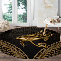 Round dark carpet featuring a gold Eye of Horus and feather, geometric trim