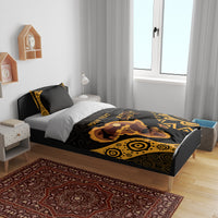 Personalized bedding set in bedroom: black and gold elephant-and-pattern design with matching pillows
