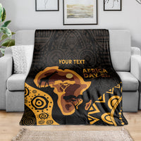 Personalized Africa Day blanket draped on sofa, black and gold camel and map design.