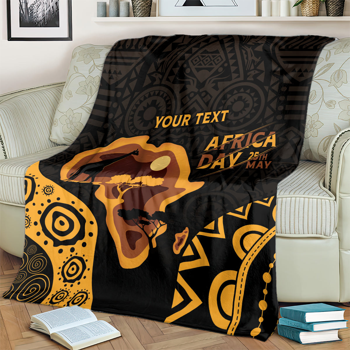 Africa Day blanket with 'YOUR TEXT' over bed, black and gold retro ethnic pattern.