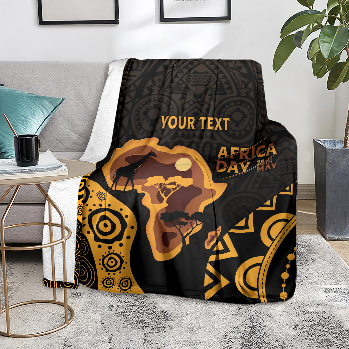 Personalized Africa Day blanket on chair, black and gold camel and map artwork.