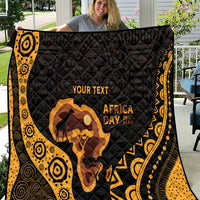 Personalized quilt draped outdoors in black and gold, featuring Africa silhouette and 'YOUR TEXT'.
