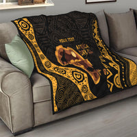Personalized quilt folded on sofa in black and gold, featuring Africa silhouette and 'AFRICA DAY'.