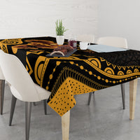 Black tablecloth with gold tribal patterns and dotted accents, styled on dining table