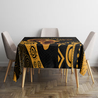 Black and gold patterned tablecloth with geometric motifs and animal silhouette, square