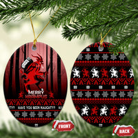 Two hanging black ceramic Krampus Christmas ornaments with red striped print; front and back shown.