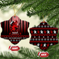 Two hanging black ceramic Krampus Christmas ornaments with red artwork; front and back labels shown.
