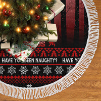 Fringed black Christmas tree skirt with red-and-white festive border and pattern.