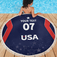 Round navy beach blanket with white fringe, bold 'YOUR TEXT 07 USA' design