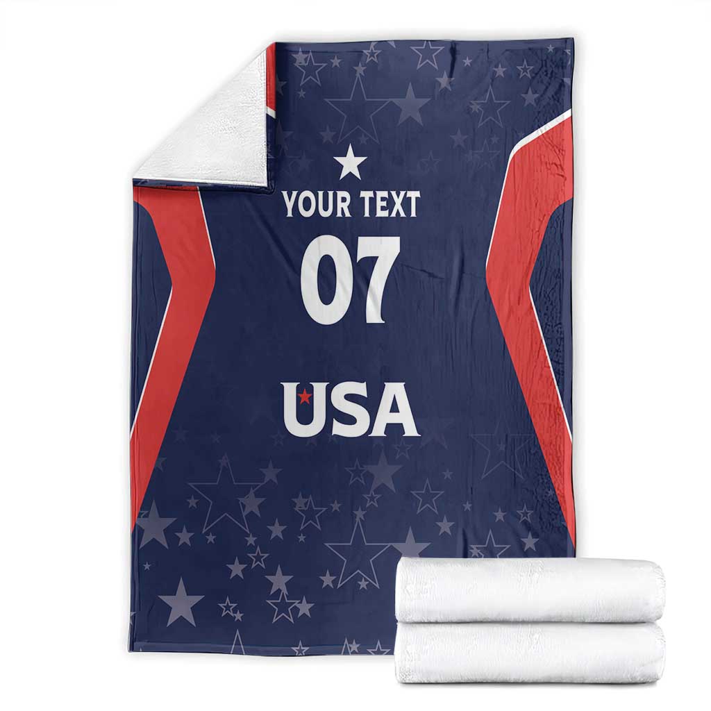 Navy blanket with red stripe sides, stars, and 'YOUR TEXT 07 USA' text, with folded stack