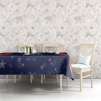 Blue star-pattern tablecloth with red border draped on a dining table