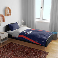 USA-themed blue bedding set on bed with “USA” logo, red stripes, and star pattern