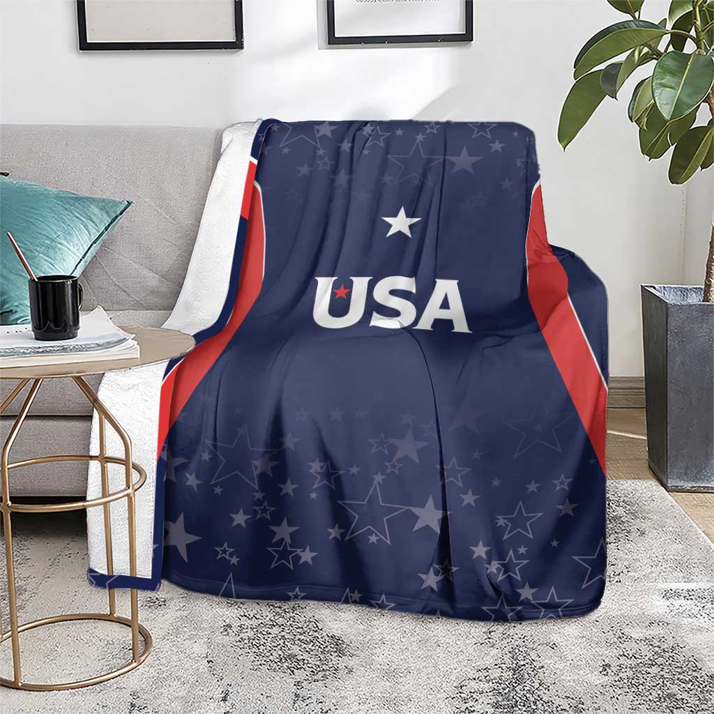 Navy USA-themed blanket with 'USA' text and star pattern, spread on floor rug