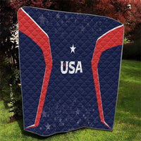 USA quilt blanket on grass, navy blue with red trim, central USA logo and star.