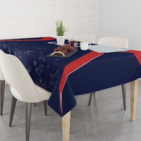 Navy blue tablecloth with star motifs and red-edged border, covering a rectangular table